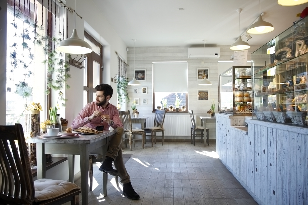Man social distancing in a quiet coffee shop