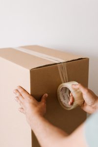 Man sealing a cardboard box